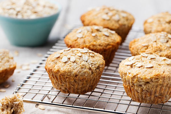 Healthy vegan oat muffins, apple, banana cakes on cooling rack