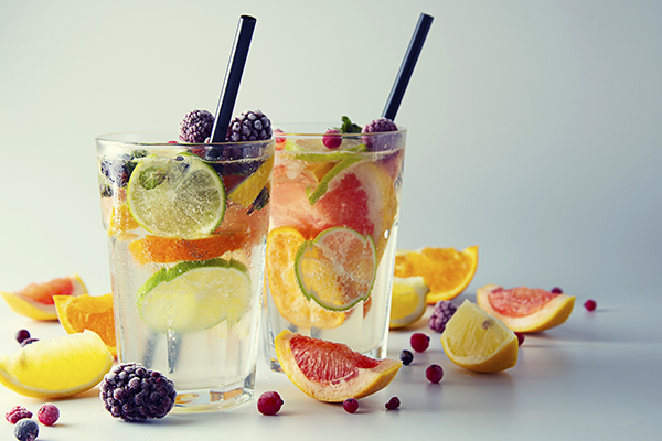 Water with various fruits in a glass