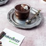 Chocolate Shakeology Pudding in a glass cup on silver tray