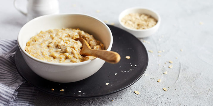 Premium Photo  Closeup of a person making oatmeal with milk in a pot on  the stove