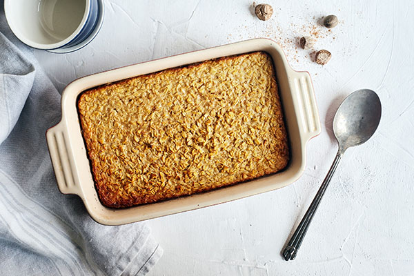 This easy oven Baked Oatmeal recipe features old-fashioned rolled oats, raw honey, and unsweetened applesauce for a touch of natural sweetness.