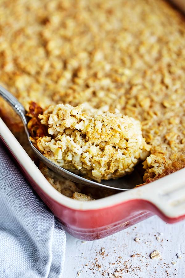 This easy oven Baked Oatmeal recipe features old-fashioned rolled oats, raw honey, and unsweetened applesauce for a touch of natural sweetness.