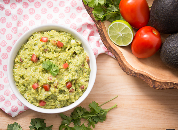 Refine your technique and learn a few new tricks with our recipe for the ideal Guacamole featuring zesty lime, cilantro, and fresh tomatoes.