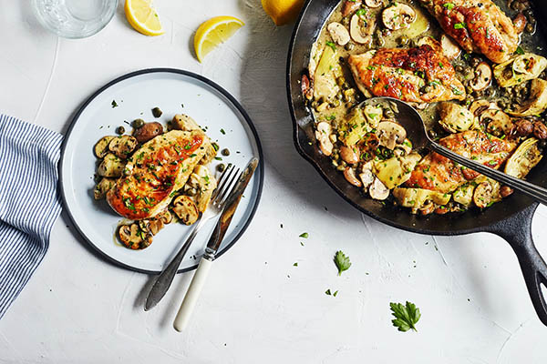 This healthier chicken piccata recipe is prepared in the classic style and topped with flavorful mushrooms, artichokes, and capers.