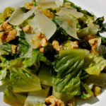 This easy Grilled Romaine salad is an ideal BBQ side with grilled romaine, crunchy walnuts, and shaved parmesan topped with a tangy lemon dijon dressing.