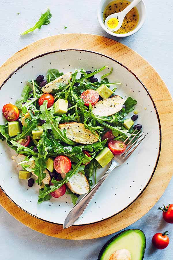 This hearty arugula salad with chicken has only 5 ingredients and can be made in minutes. Black beans, and avocado make it a satisfying lunch or dinner.