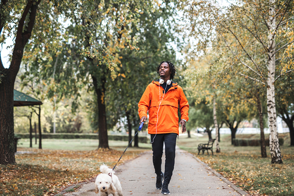 man walking dog in park