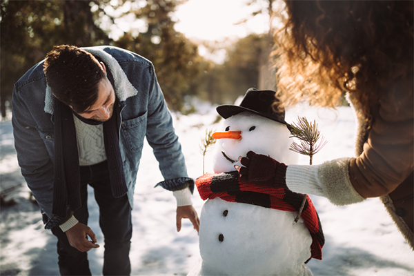 couple building snowman | date ideas