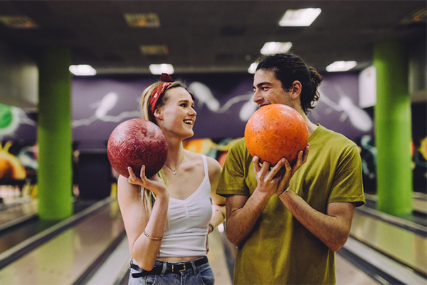 couple holding bowling balls | date ideas