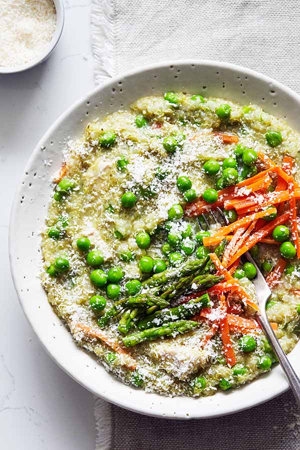 This Slow Cooker Chicken recipe features quinoa, spring vegetables, and tender chicken breast for a light but hearty weeknight dinner.