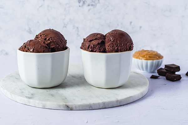 Two white bowls of Chocolate Peanut Butter Shakeology Ice Cream