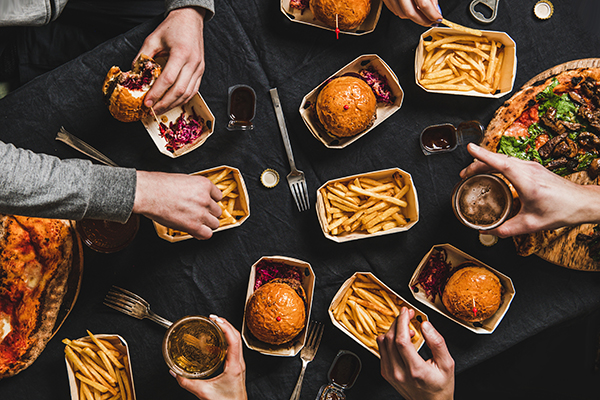 Overhead shot of friends eating burgers