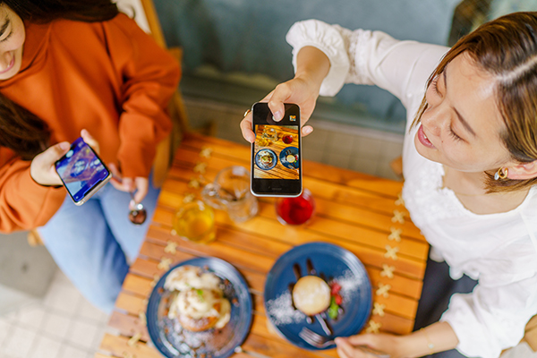 Women taking dessert photos for social media