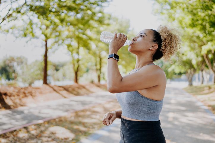 Woman Drinks Water While on Run | Sports Drink