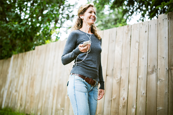 woman with earphones walking | 10,000 Steps