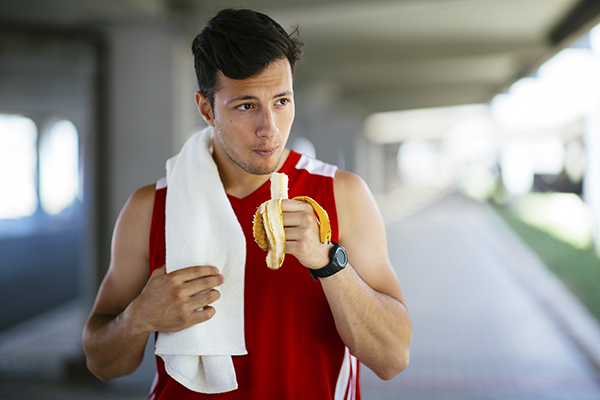 Runner taking a break, eating banana