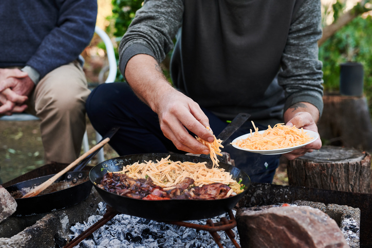 People Cook Meal Outdoors with Skillet | Cast-Iron Skillet