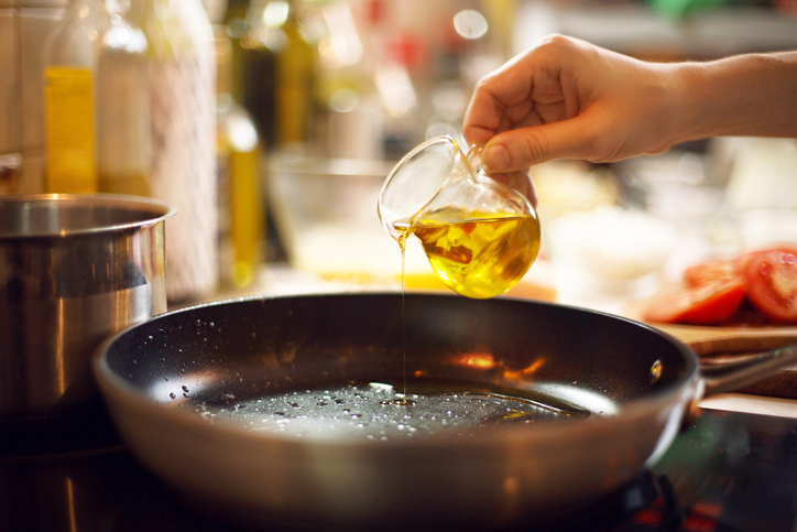 Oil Being Poured Onto Skillet | Cast-Iron Skillet
