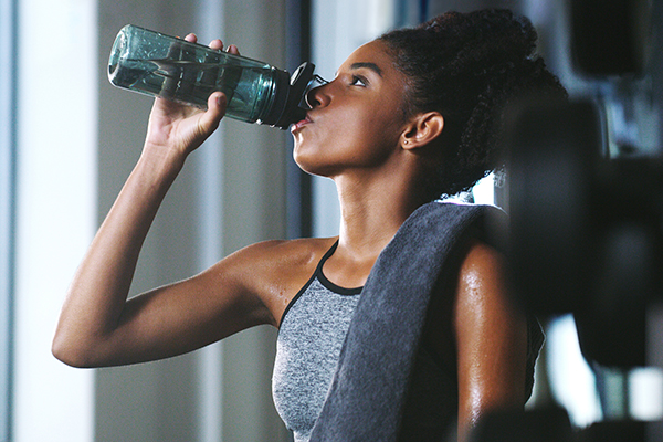 Woman drinking water after workout