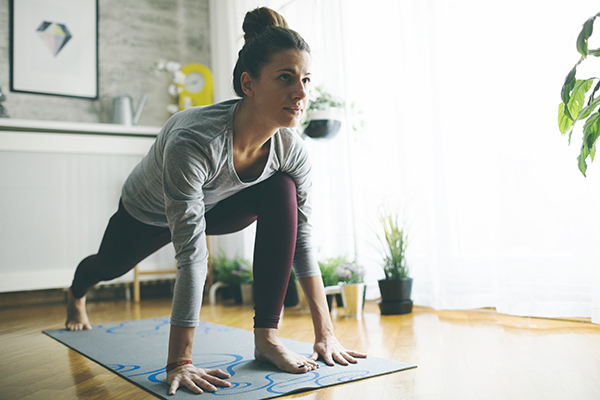 Woman practicing yoga at home