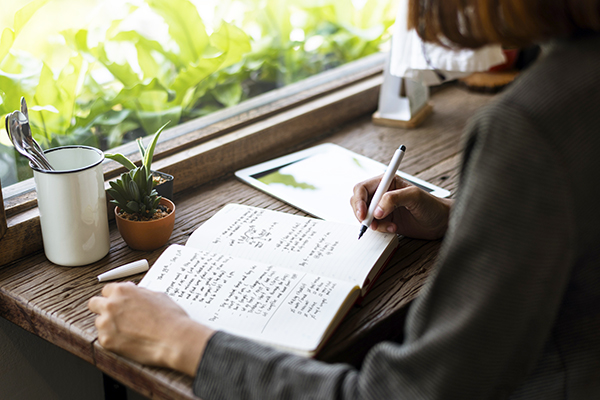 Woman writing in journal