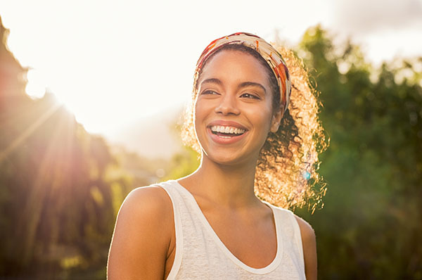 woman smiling in sunlight | how to lose weight on the night shift