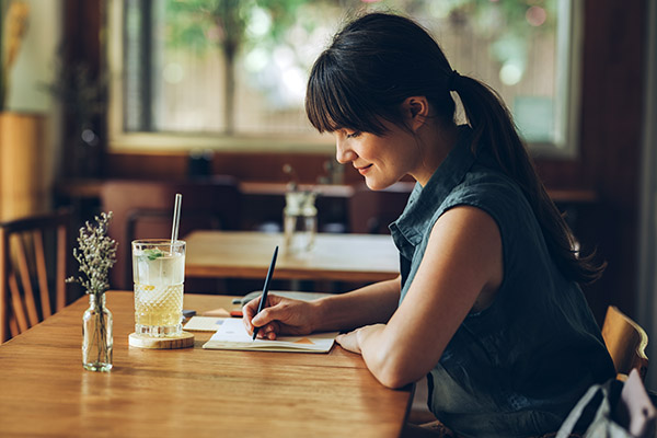Woman writing in food journal