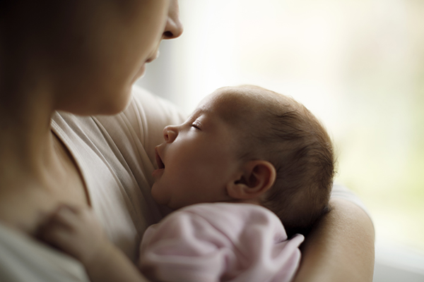 Woman holding baby in her arms