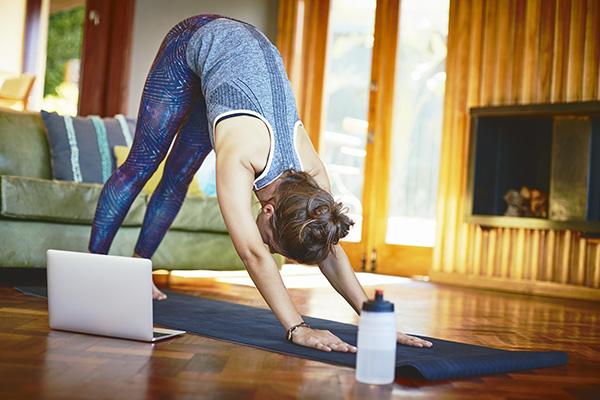 Woman doing yoga moves at home