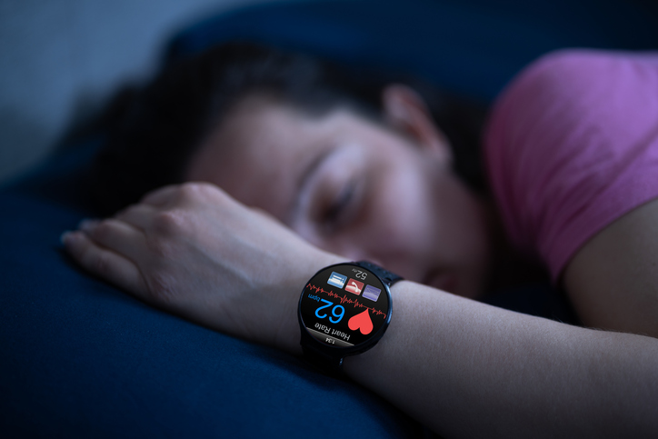 Woman Using Wearable to Track Sleep | Eating Before Bed