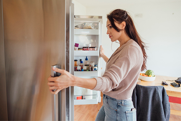 woman looking in fridge | Are You Really Hungry