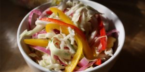 This healthier Cabbage Slaw is a perfect compliment to almost any protein featuring colorful bell peppers, red onion, and tangy rice wine vinegar.