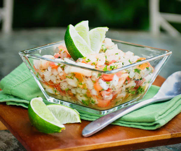 Shrimp ceviche with lime wedges