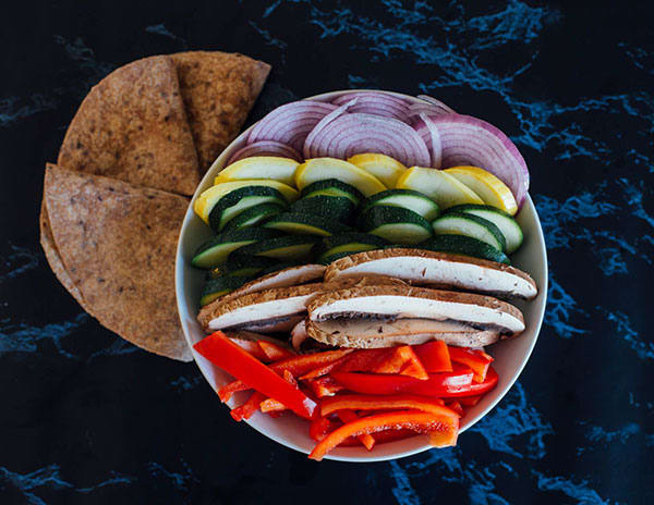 This healthier Grilled Veggie Quesadilla with Basil Pesto features Portobello mushroom, summer squash, zucchini, red bell pepper and whole wheat tortillas. 