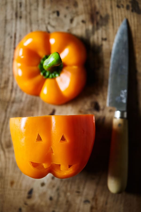 These cute little Jack-O'-Lantern Stuffed Peppers are filled with a fiesta-inspired mix of spices, ground turkey, and black beans.