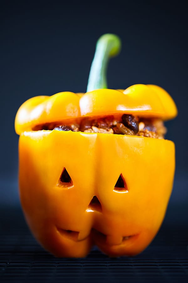 These cute little Jack-O'-Lantern Stuffed Peppers are filled with a fiesta-inspired mix of spices, ground turkey, and black beans.