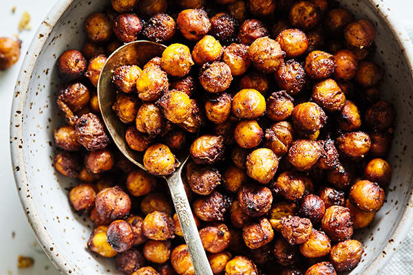 These Maple Chai Roasted Chickpeas are a cravable crunchy snack featuring savory a ginger, cardamom, and clove spice blend.