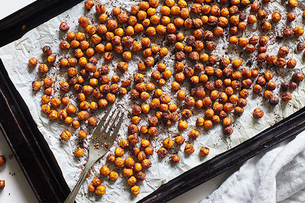 These Maple Chai Roasted Chickpeas are a cravable crunchy snack featuring savory a ginger, cardamom, and clove spice blend.