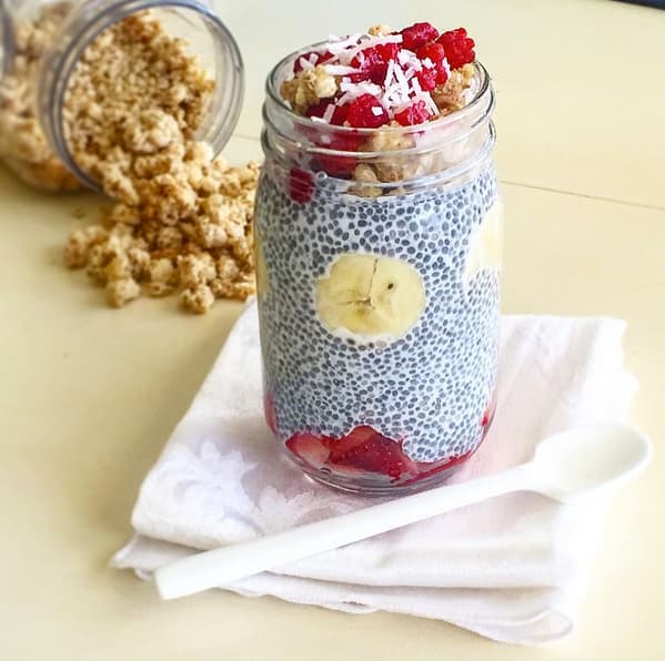 Meal prep snacks chia pudding with banana, strawberries, and granola in a Mason jar