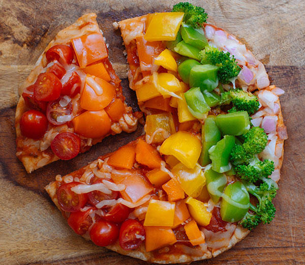 Covered in a vibrant vegetable medley of red onion, three colors of bell peppers, and broccoli florets this Rainbow Veggie Flatbread Pizza is always a hit.