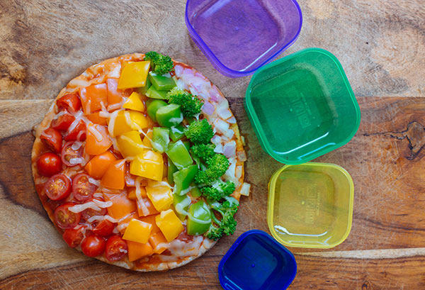 Covered in a vibrant vegetable medley of red onion, three colors of bell peppers, and broccoli florets this Rainbow Veggie Flatbread Pizza is always a hit.