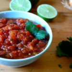 This rich, smoky roasted tomato salsa can be made in minutes featuring chopped cilantro, fresh lime juice, garlic, onion, and fiery jalapeño peppers.