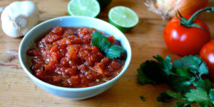 This rich, smoky roasted tomato salsa can be made in minutes featuring chopped cilantro, fresh lime juice, garlic, onion, and fiery jalapeño peppers.