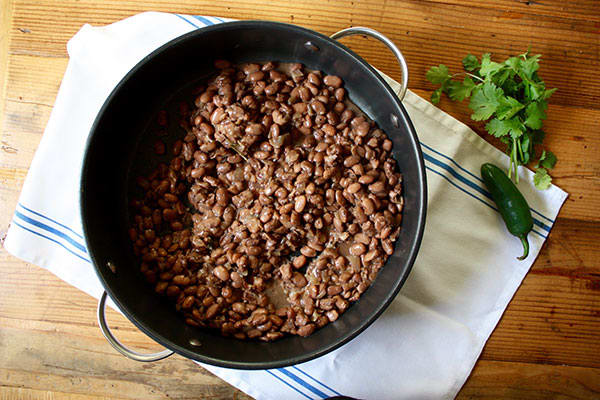 These delicious slow cooker refried beans combine onion, garlic, salt, pepper, and a dash of heat and freeze well for later too! 