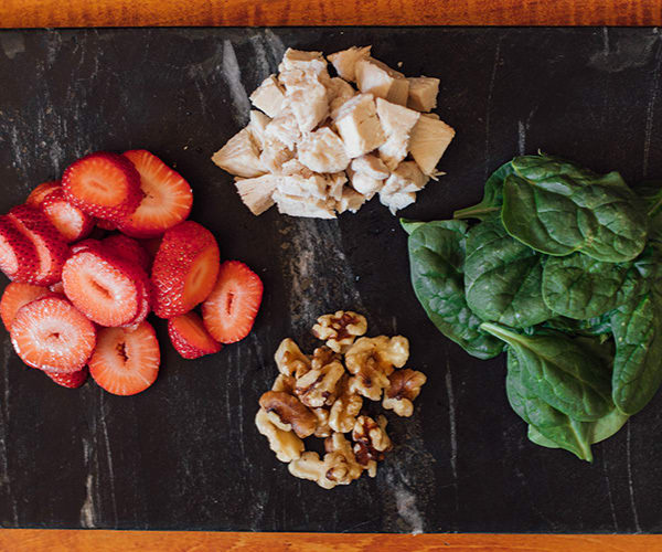 spinach salad with strawberries, chicken, and walnuts