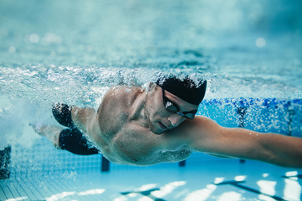 man swimming laps | Swimming Workouts