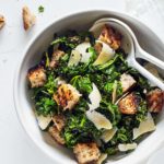 This Healthier Caesar Salad features savory Parmesan cheese, whole wheat garlic croutons, and a tangy lemon garlic dressing.
