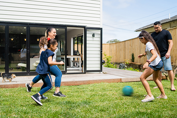 Family playing soccer outside