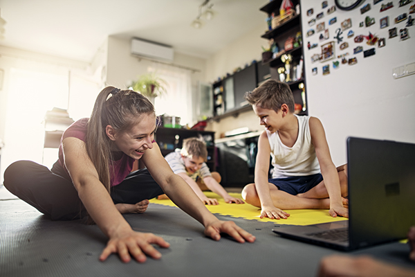 Kids stretching on the floor at home