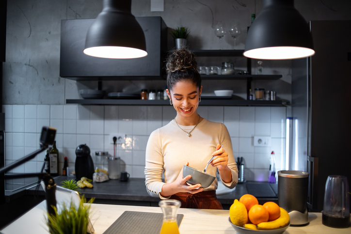 woman eating in kitchen | Counting Macros for Weight Loss